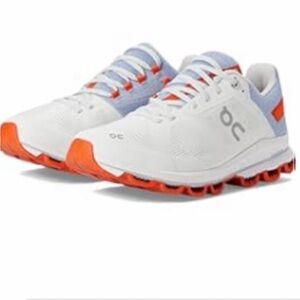 On Running White and Orange Athletic Shoes